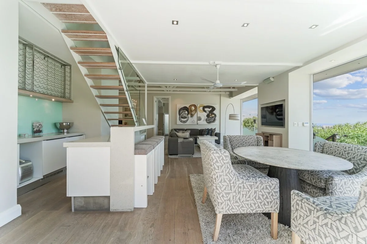 Dining space beside the glass staircase