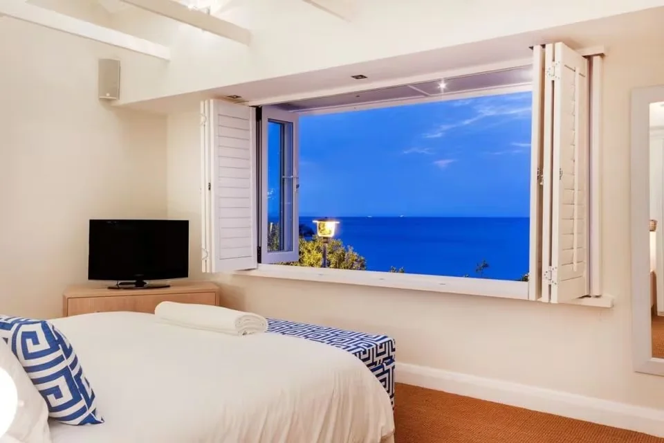 Bedroom opening to a blue Atlantic view